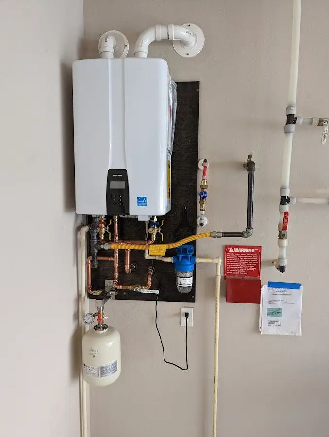 Professional plumber installing copper piping in a Newcastle home